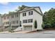 Charming townhome featuring a freshly painted exterior, an attached garage, and a beautifully landscaped front yard at 208 Wade Creek Rd, Alpharetta, GA 30009