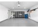 Well-organized garage space with ample storage cabinets, a clean epoxy floor, and room for parking vehicles at 208 Wade Creek Rd, Alpharetta, GA 30009