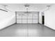 Clean and spacious garage with a modern door and an epoxy floor at 208 Wade Creek Rd, Alpharetta, GA 30009