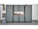 View of a well organized garage featuring gray cabinets and hanging skateboards at 208 Wade Creek Rd, Alpharetta, GA 30009
