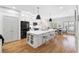 Bright kitchen featuring white cabinets, quartz countertops, and an island with bar seating at 208 Wade Creek Rd, Alpharetta, GA 30009