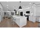 Bright, spacious kitchen featuring a center island, stainless steel appliances, and an open layout to the living room at 208 Wade Creek Rd, Alpharetta, GA 30009