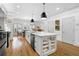 A modern kitchen featuring an island with bar seating, storage, and stainless steel appliances at 208 Wade Creek Rd, Alpharetta, GA 30009