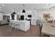 Modern kitchen with a large island, white cabinets, stainless appliances, and open to dining area at 208 Wade Creek Rd, Alpharetta, GA 30009