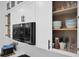 Close up of kitchen featuring a built in microwave and neatly organized cabinet at 208 Wade Creek Rd, Alpharetta, GA 30009