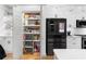 A kitchen features a full pantry next to the refrigerator at 208 Wade Creek Rd, Alpharetta, GA 30009