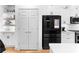 Spacious kitchen with black stainless steel refrigerator and bright white pantry at 208 Wade Creek Rd, Alpharetta, GA 30009