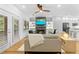 A modern living room showcasing a sleek fireplace and connecting to the kitchen area at 208 Wade Creek Rd, Alpharetta, GA 30009