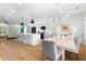 Open concept living space with a gourmet kitchen with island, and a dining room with a modern chandelier at 208 Wade Creek Rd, Alpharetta, GA 30009