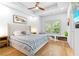 Serene main bedroom with hardwood floors, tray ceiling, and ample natural light at 208 Wade Creek Rd, Alpharetta, GA 30009