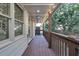 Side porch featuring brown wood flooring, railings and wood pillars at 208 Wade Creek Rd, Alpharetta, GA 30009