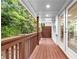 Covered porch with wooden flooring and railings, offering a serene outdoor space at 208 Wade Creek Rd, Alpharetta, GA 30009