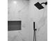 Close up of shower featuring a dark rain head and marbled tile wall at 208 Wade Creek Rd, Alpharetta, GA 30009