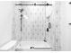 Stylish bathroom with a white tub-shower featuring black geometric tile, matte black hardware, and glass doors at 208 Wade Creek Rd, Alpharetta, GA 30009
