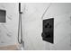 Shower controls on marbled tile wall, including temperature controls and shower head at 208 Wade Creek Rd, Alpharetta, GA 30009