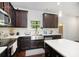 Well-lit kitchen features granite countertops, modern appliances and a breakfast bar at 2517 Hedgeway Cir, Kennesaw, GA 30144