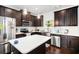 Modern kitchen featuring dark cabinets, white subway tile backsplash, and stainless steel appliances at 2517 Hedgeway Cir, Kennesaw, GA 30144