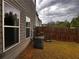 Home exterior featuring a wood fence, grass, and an air conditioning unit at 2778 Wild Laurel Ct, Norcross, GA 30071