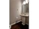 Half bathroom with a pedestal sink, dark wood floors, and neutral wall paint at 2778 Wild Laurel Ct, Norcross, GA 30071