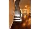 Entryway with hardwood floors that leads to a spacious living room with white trim stairs and dark brown handrail at 2778 Wild Laurel Ct, Norcross, GA 30071