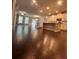 Hardwood floors leading into an open-concept kitchen with stainless appliances, white cabinets, and stone countertops at 2778 Wild Laurel Ct, Norcross, GA 30071