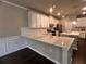 Bright kitchen featuring a quartz counter, white cabinets, stainless appliances, and dark hardwood floors at 2778 Wild Laurel Ct, Norcross, GA 30071
