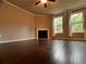Spacious living room featuring hardwood floors, fireplace, and two large windows to allow natural light at 2778 Wild Laurel Ct, Norcross, GA 30071