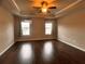 Spacious main bedroom with tray ceiling, ceiling fan, and bright windows at 2778 Wild Laurel Ct, Norcross, GA 30071