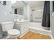 Cozy bathroom with a shower-tub combo, white vanity, and wood-look flooring at 5247 Yeager Rd, Douglasville, GA 30135
