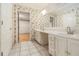 Bathroom with double vanity and floral wallpaper at 5247 Yeager Rd, Douglasville, GA 30135