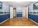 Bedroom featuring blue wallpaper, a closet, and access to additional rooms at 5247 Yeager Rd, Douglasville, GA 30135