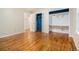 Bright bedroom featuring hardwood floors, a closet, and access to another room at 5247 Yeager Rd, Douglasville, GA 30135