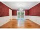 Elegant dining room with decorative wallpaper, chandelier, and french doors at 5247 Yeager Rd, Douglasville, GA 30135