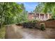 View of the property's long paved driveway winding through the greenery leading up to the house at 5247 Yeager Rd, Douglasville, GA 30135