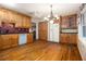 Traditional kitchen with wooden cabinets, hardwood floors, and modern appliances at 5247 Yeager Rd, Douglasville, GA 30135