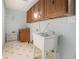 Functional laundry room with utility sink, ample cabinet storage, and practical flooring at 5247 Yeager Rd, Douglasville, GA 30135