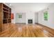 Bright, open living room with hardwood floors and a decorative fireplace feature at 5247 Yeager Rd, Douglasville, GA 30135