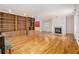 Open living space with hardwood floors, fireplace, and large built-in bookcase at 5247 Yeager Rd, Douglasville, GA 30135