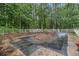 Backyard pool covered for the off-season, surrounded by mature trees and a white fence at 5247 Yeager Rd, Douglasville, GA 30135
