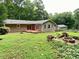 Backyard featuring a fire pit, a small deck, and a lush green lawn at 364 Stafford Sw St, Marietta, GA 30064