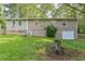 Backyard featuring a well-maintained lawn, mature trees, and partial home view at 364 Stafford Sw St, Marietta, GA 30064