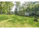 Backyard showcasing a well-maintained lawn, mature trees, and outdoor space at 364 Stafford Sw St, Marietta, GA 30064