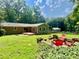 This backyard features a lush green lawn, a fire pit, a patio, and mature trees for privacy at 364 Stafford Sw St, Marietta, GA 30064