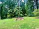 Enjoy nature in the expansive backyard with a fire pit surrounded by mature trees at 364 Stafford Sw St, Marietta, GA 30064
