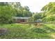 Backyard showcasing a deck, firepit area, and mature trees at 364 Stafford Sw St, Marietta, GA 30064