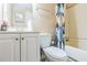 Practical bathroom with a toilet, vanity, and shower tub with stylish shower curtains at 364 Stafford Sw St, Marietta, GA 30064