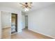 Cozy bedroom featuring hardwood floors, ceiling fan, and a mirrored closet for extra storage at 364 Stafford Sw St, Marietta, GA 30064