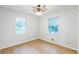 A bright bedroom that features neutral walls, hardwood flooring, and well-lit natural light through large windows at 364 Stafford Sw St, Marietta, GA 30064