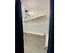 Bright walk-in closet with a modern light fixture and wood closet rods and shelf at 364 Stafford Sw St, Marietta, GA 30064