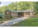 Charming home with a well-maintained exterior, featuring a long driveway and landscaping at 364 Stafford Sw St, Marietta, GA 30064